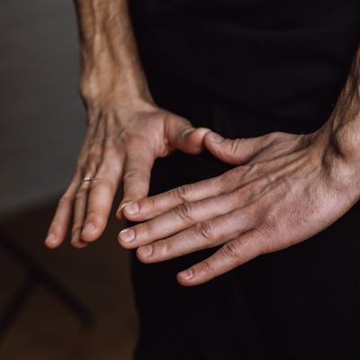 Close-up on hands in a specific yoga mudra.